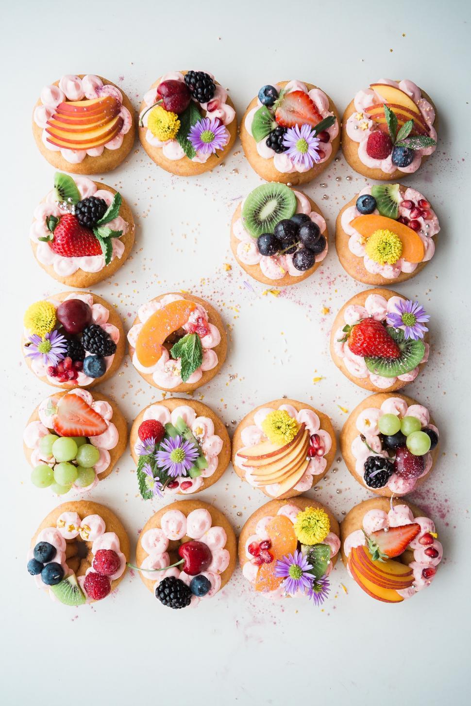 Free Image of Assorted mini fruit tarts arranged on white 