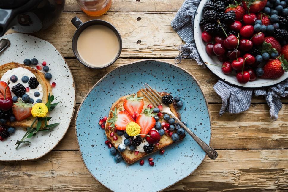 Free Image of Rustic toast with berries and edible flowers 