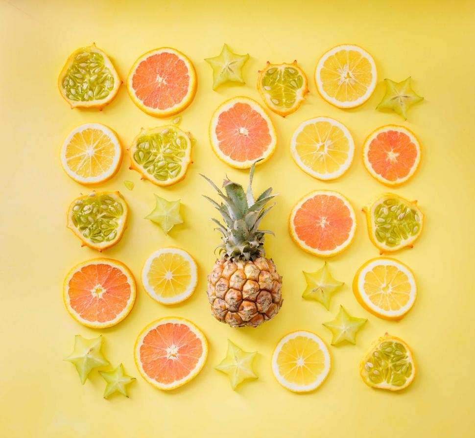 Free Image of Bright citrus fruits neatly arranged on yellow 