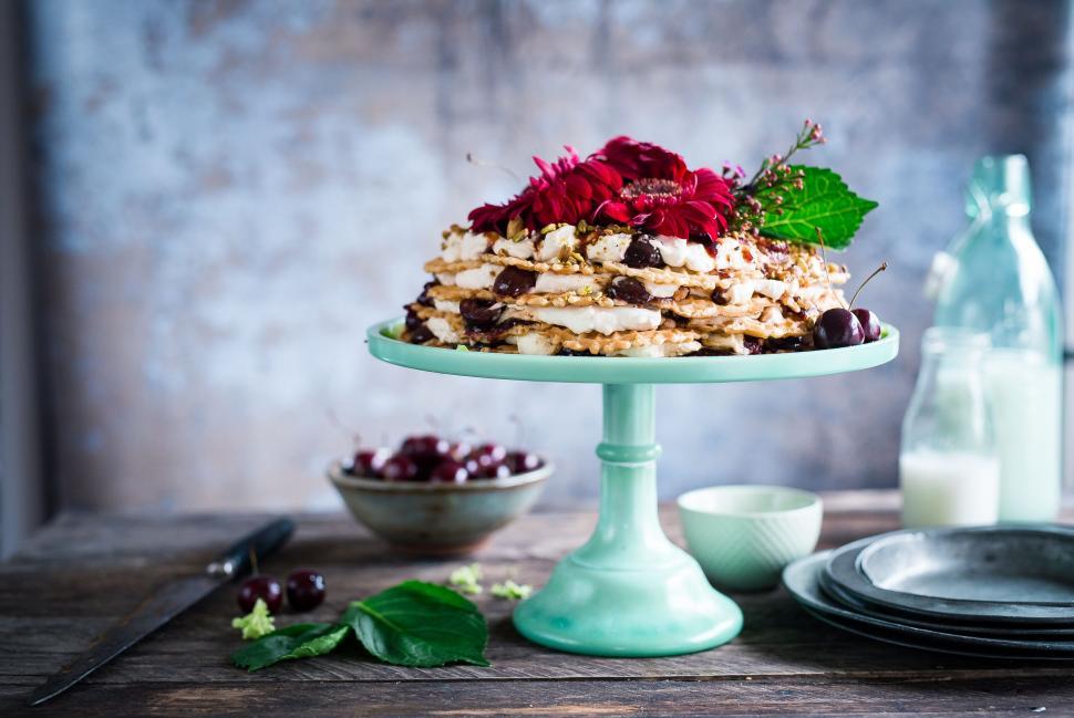 Free Image of Layered dessert on a cake stand with flowers 