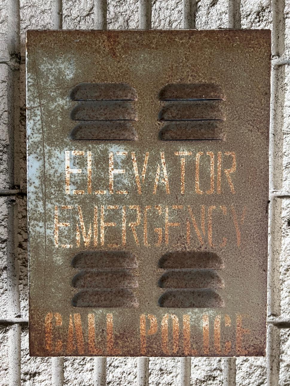 Free Image of Rusty elevator emergency sign on wall 