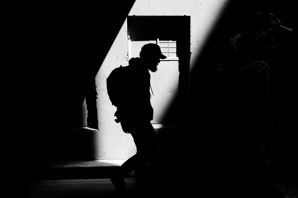 Free Image of Silhouette of a person walking in shadow 