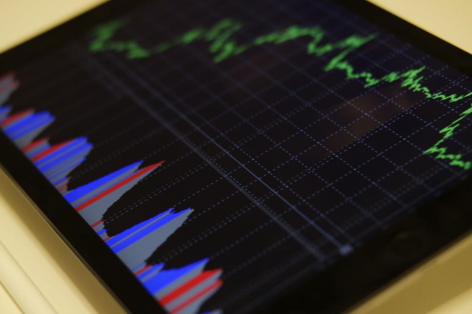 Free Image of Stock market graphs on a digital tablet screen 