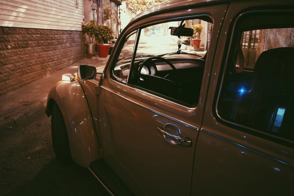 Free Image of Vintage car parked in an urban alley at night 