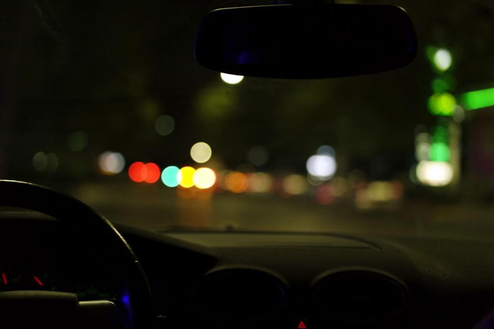 Free Image of Abstract view of car dashboard and city lights 
