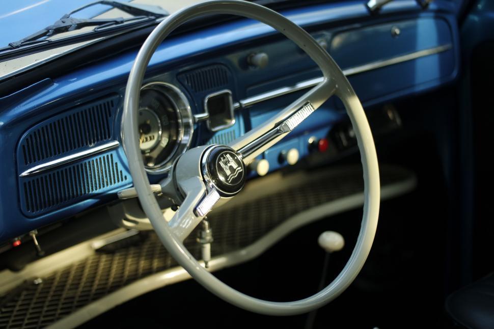 Free Image of Vintage blue car interior with white steering wheel 