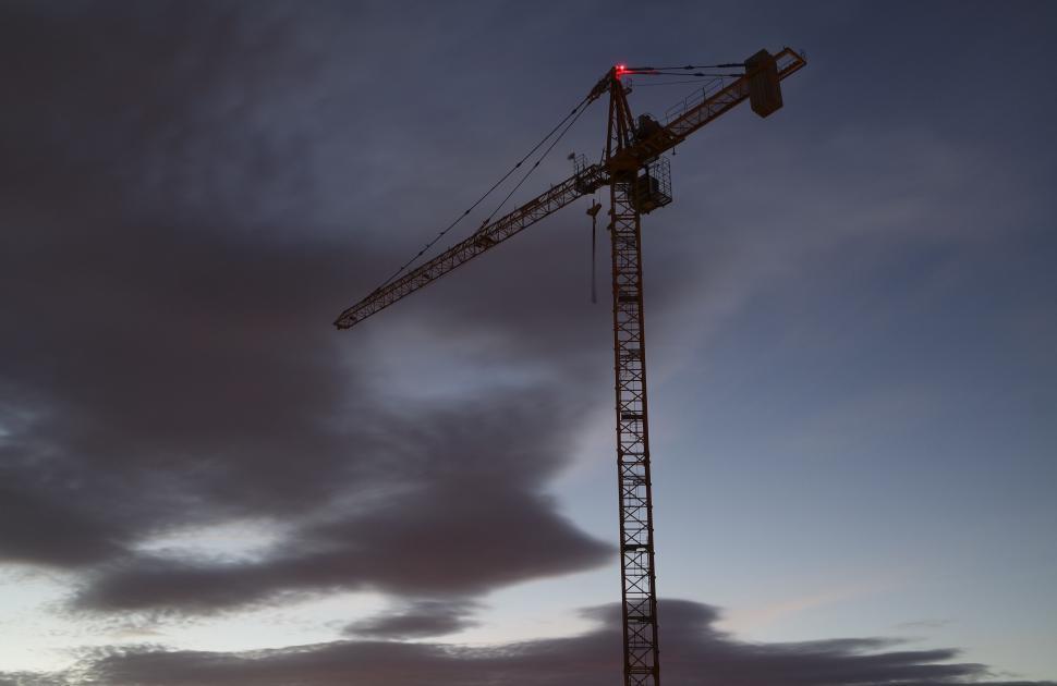 Free Image of Construction crane against twilight sky 