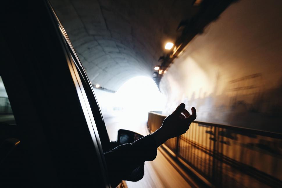 Free Image of Hand reaching out the window in a tunnel 