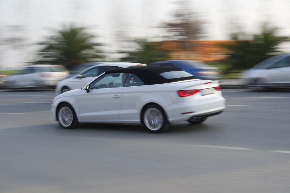 Free Image of White convertible car in motion blur 
