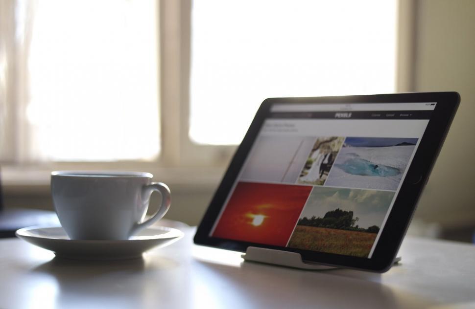 Free Image of Coffee cup and tablet displaying gallery 