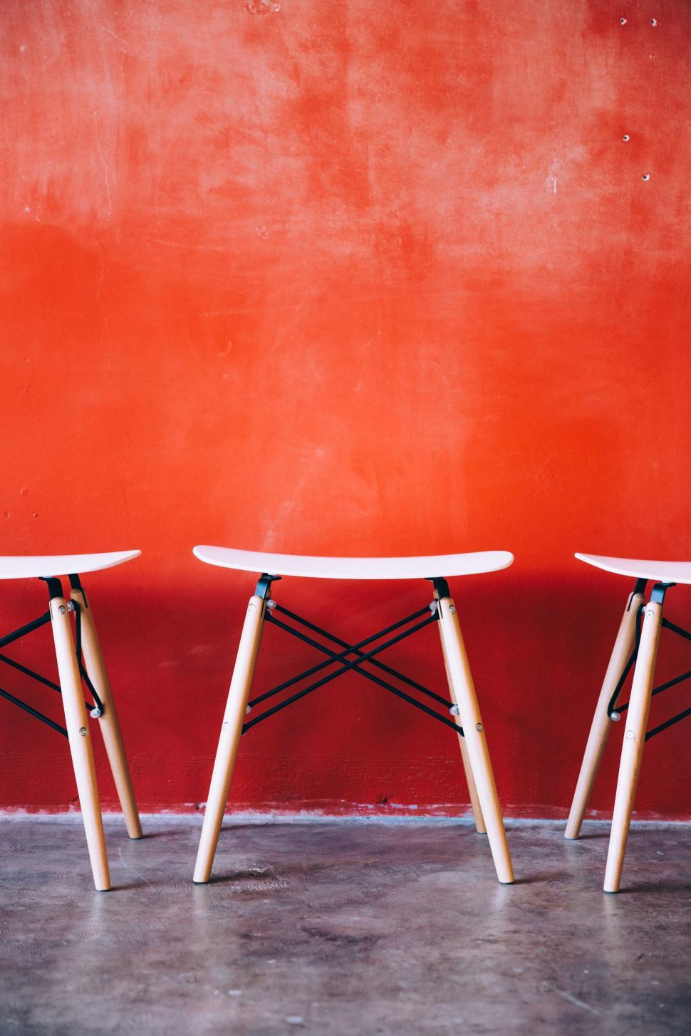 Free Image of Minimalist interior with red wall and chairs 