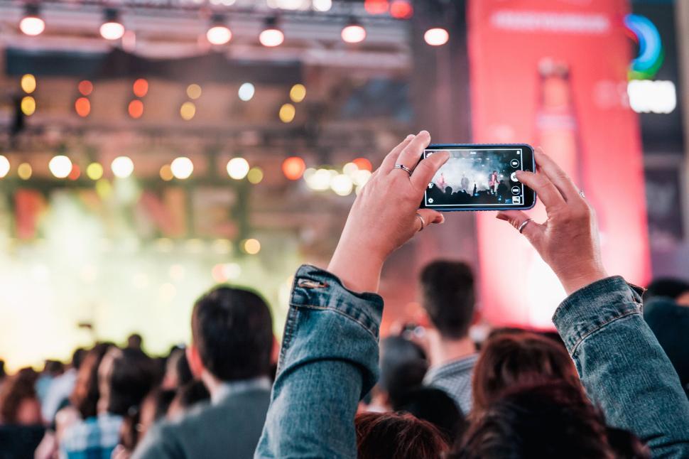 Free Image of Person capturing concert on smartphone 