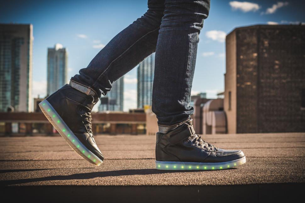 Free Image of LED shoes stepping on urban rooftop 