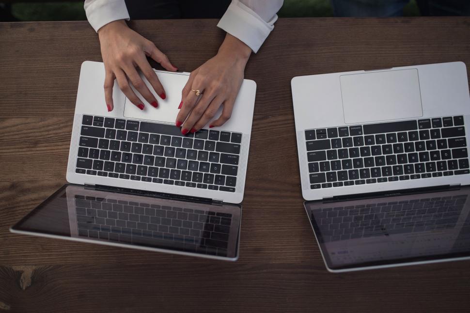 Free Image of Hands typing on a laptop in an office 