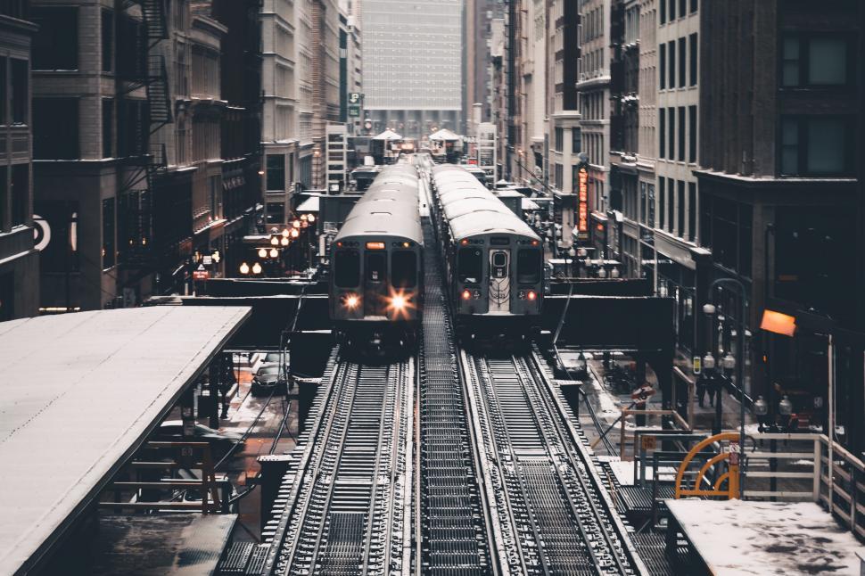 Free Image of Train on elevated tracks in snowy city 