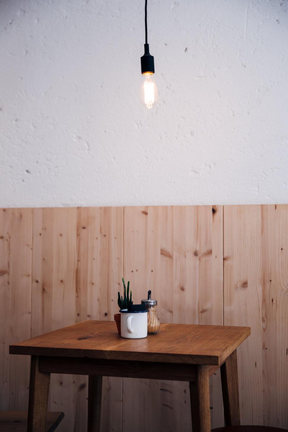 Free Image of Minimalistic table set with plant and light bulb 