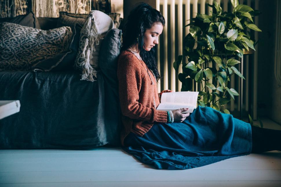 Free Image of Woman reading book in cozy room 
