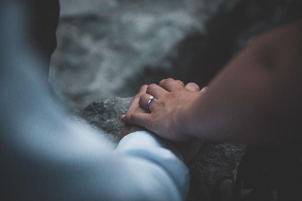 Free Image of Intimate close-up of holding hands with ring 