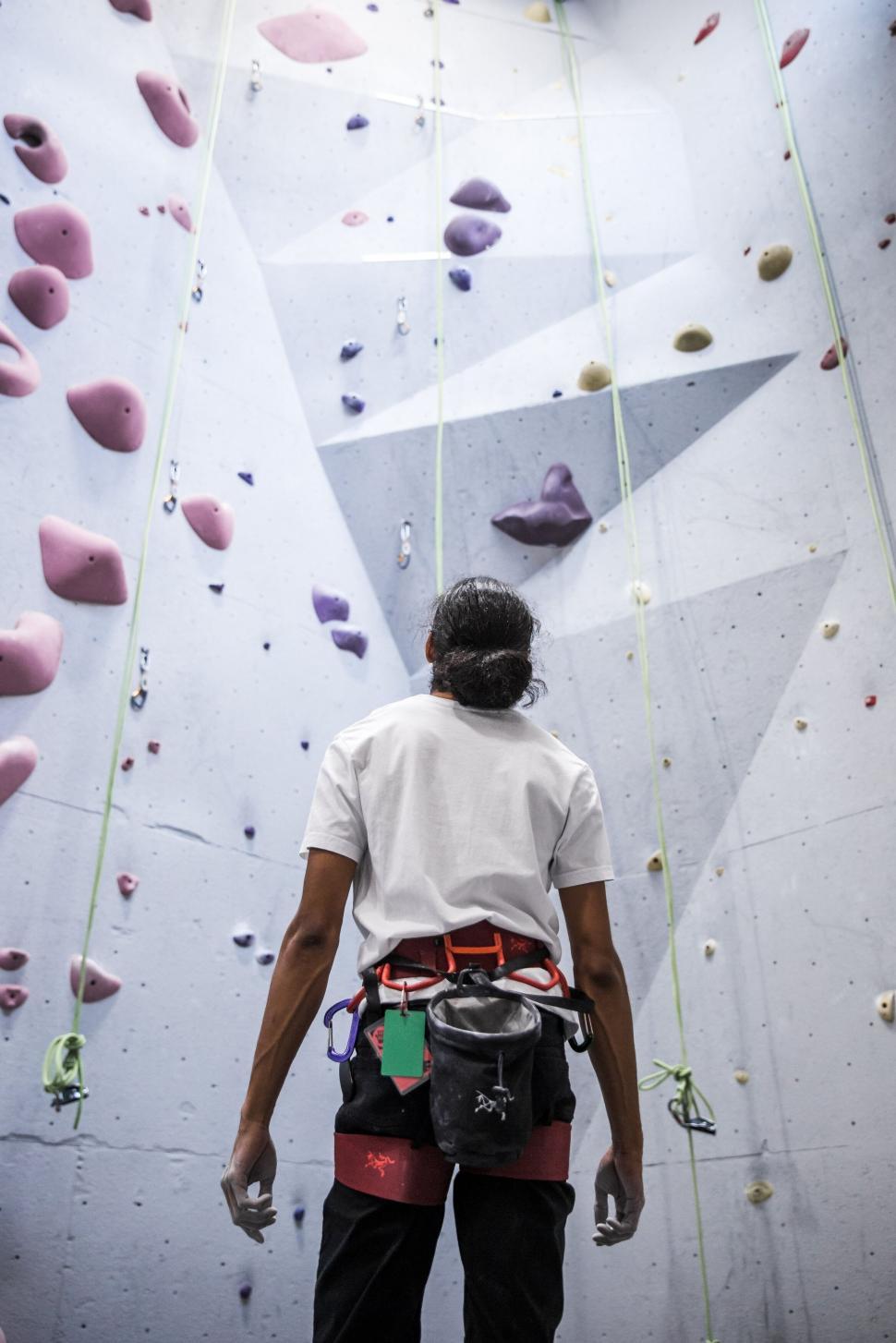 Free Image of Climber preparing for wall ascent at gym 