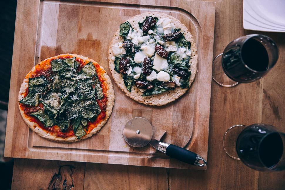Free Image of Homemade pizzas on wooden table 