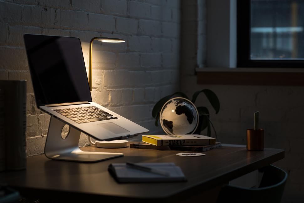 Free Image of Modern office setup with laptop and globe 