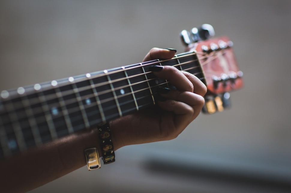 Free Image of Hand playing strings on acoustic guitar 