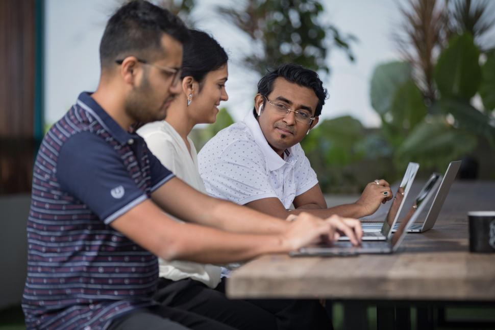 Free Image of Group working on laptop outdoors 