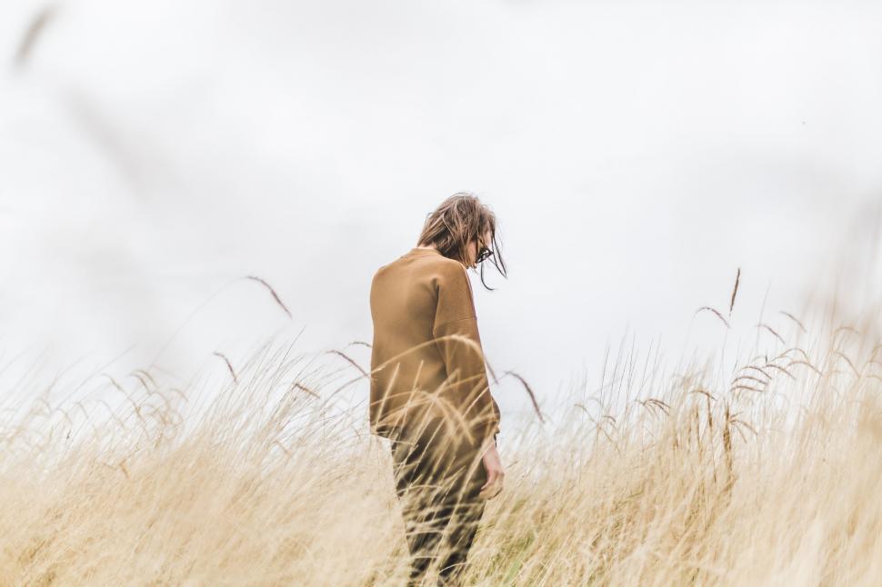 Free Image of Person in meadow with wind in hair 