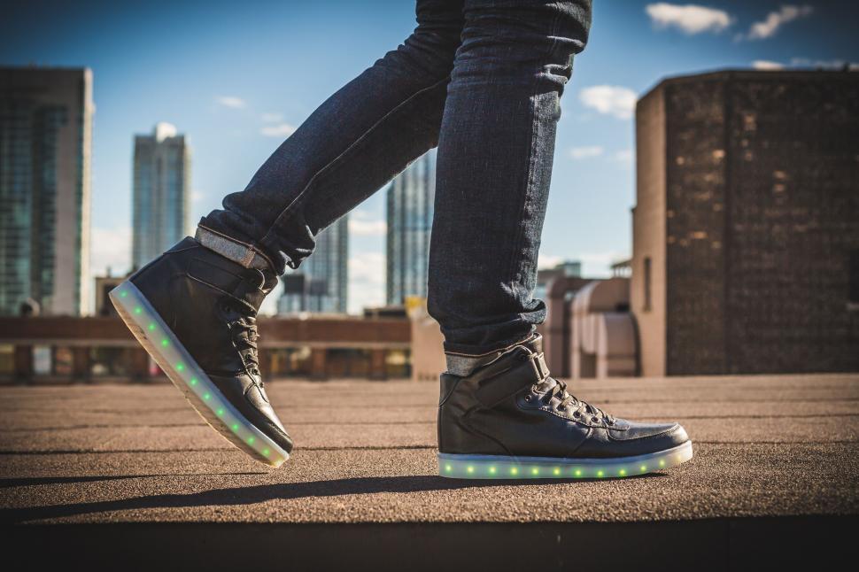 Free Image of Person with LED sneakers on rooftop 