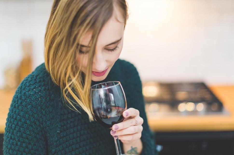 Free Image of Woman in sweater with glass of wine 