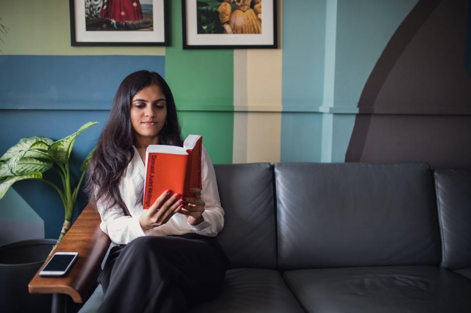 Free Image of Woman engrossed in reading a book 