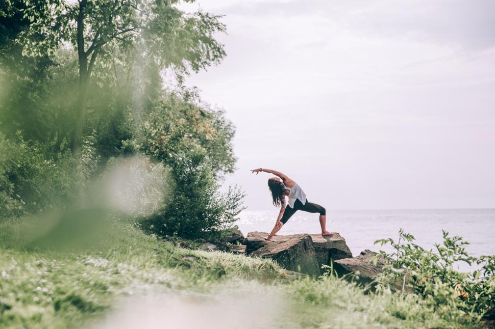 Free Image of Woman practicing yoga in a nature scene 