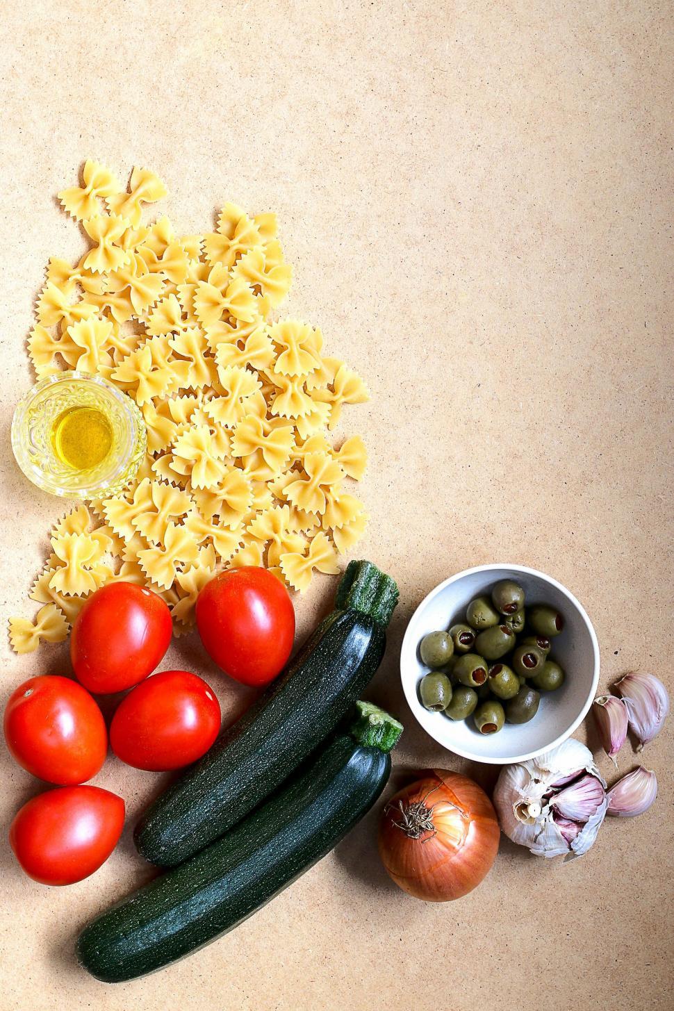 Free Image of Flat lay of vegetables and pasta on paper 