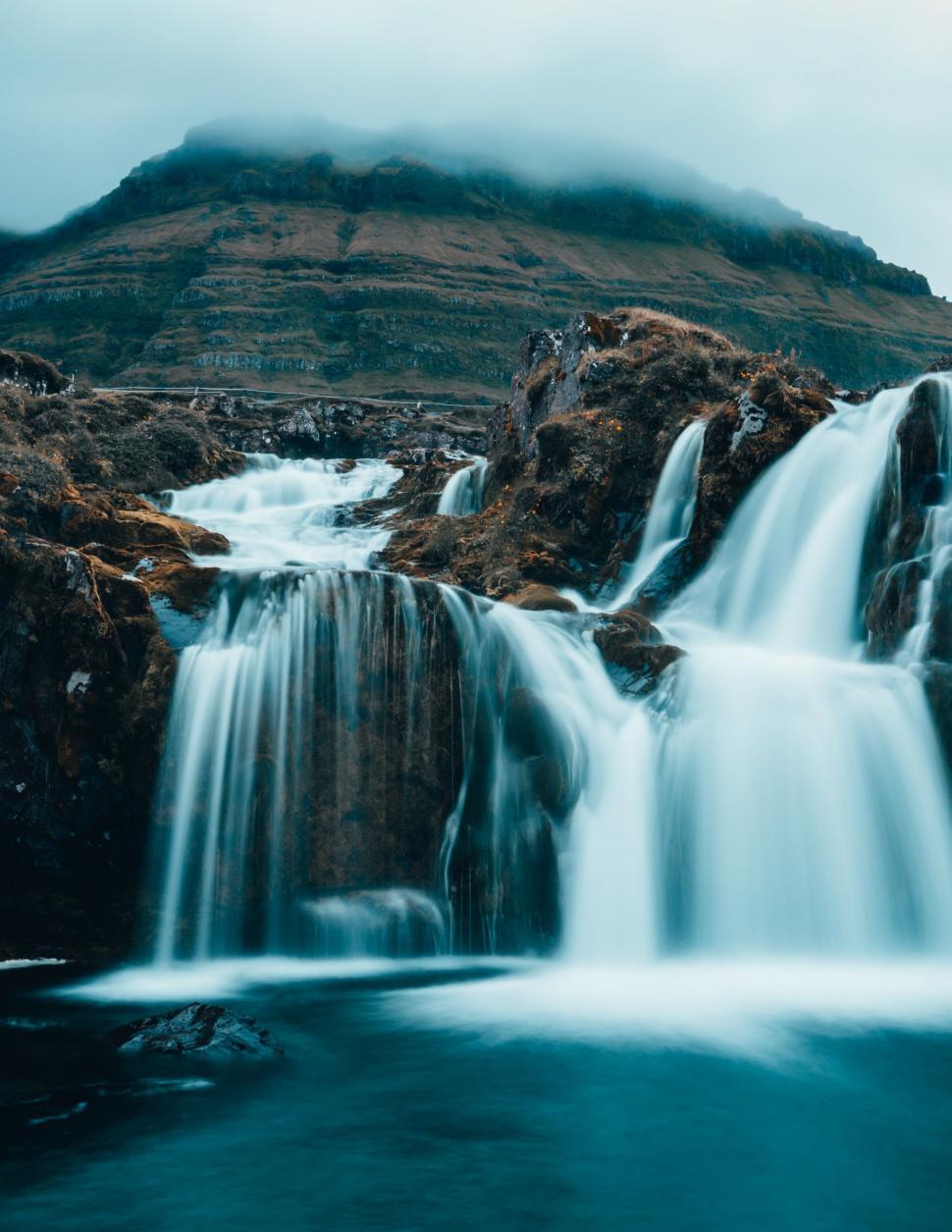 Free Image of Majestic waterfall in a misty landscape 