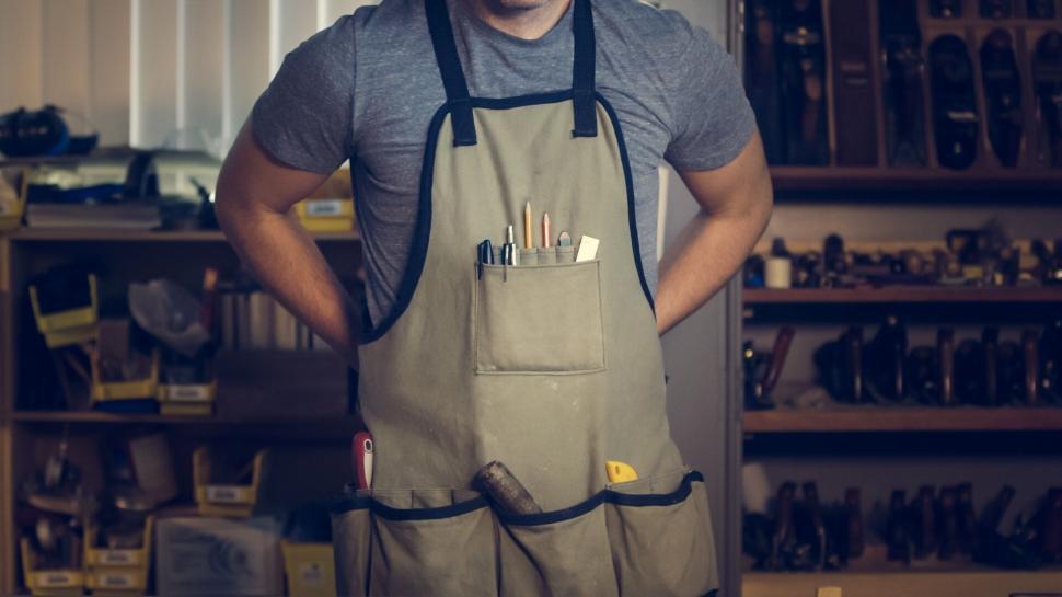 Free Image of Artisan in workshop with tools in apron 