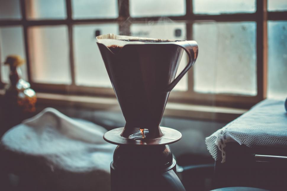 Free Image of Pour-over coffee in warm light by window 