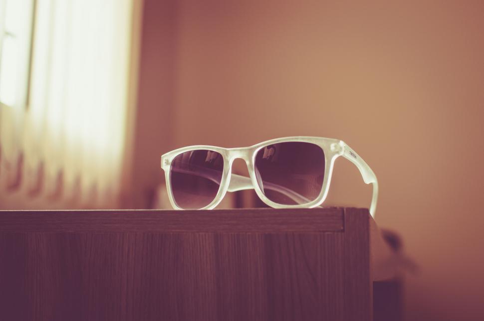 Free Image of White sunglasses on wooden edge 