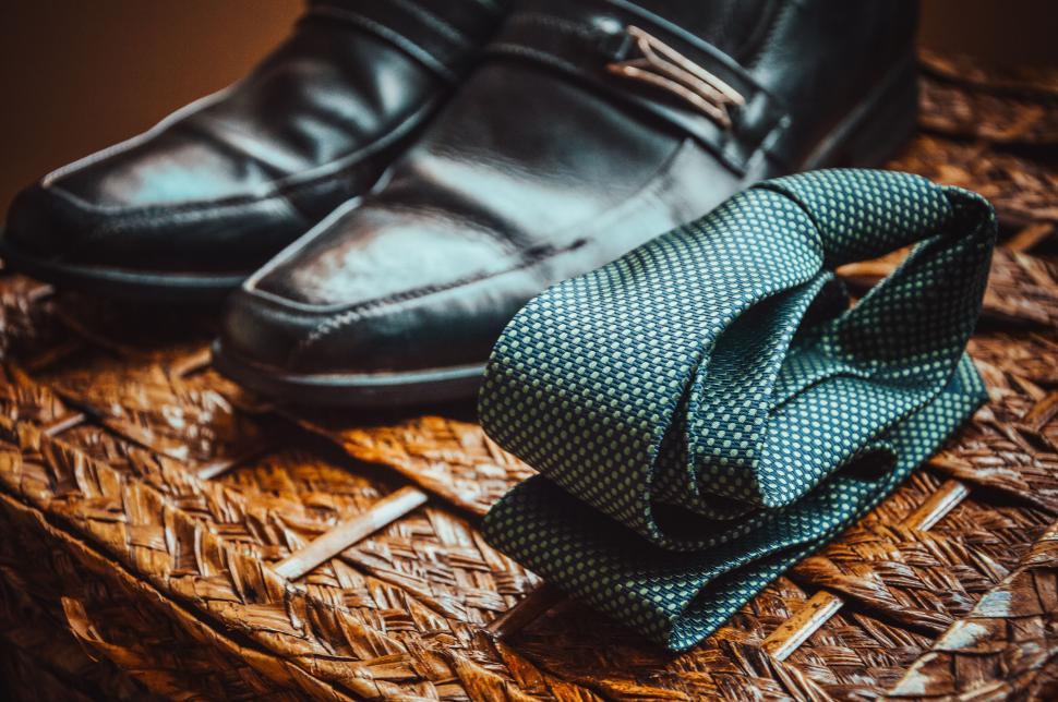 Free Image of Vintage shoes and tie on woven mat 