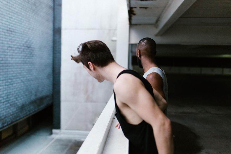 Free Image of Two Men Standing in a Parking Garage 