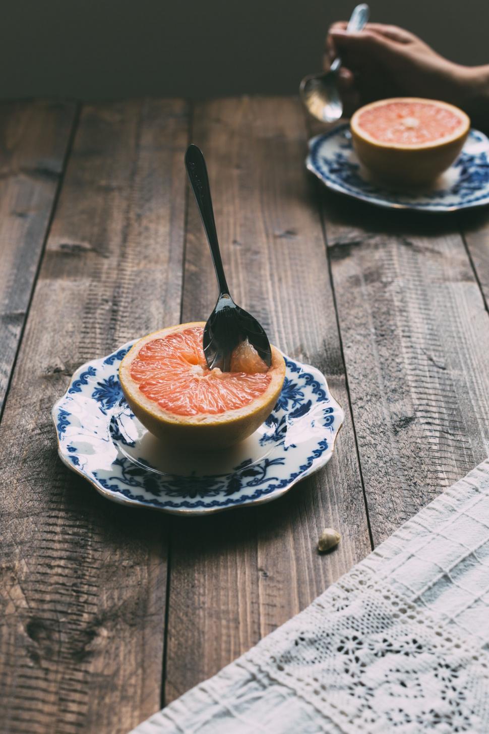 Free Image of Halved grapefruit on a patterned blue plate 