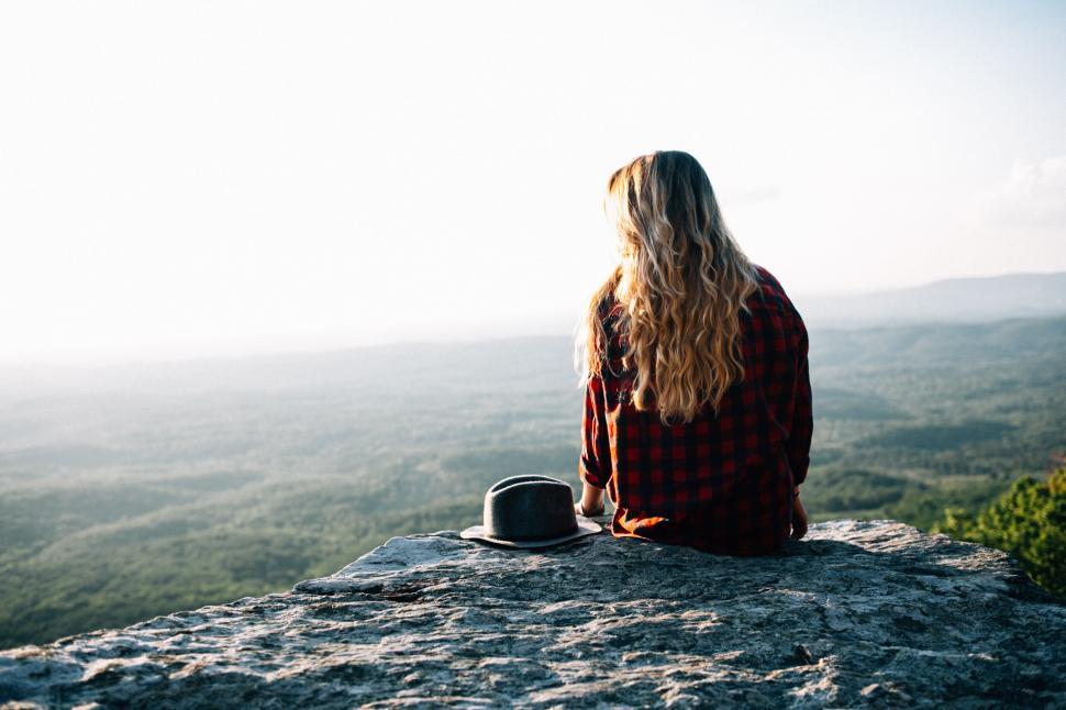 Free Image of Woman Overlooking Vast Landscape from Cliff 