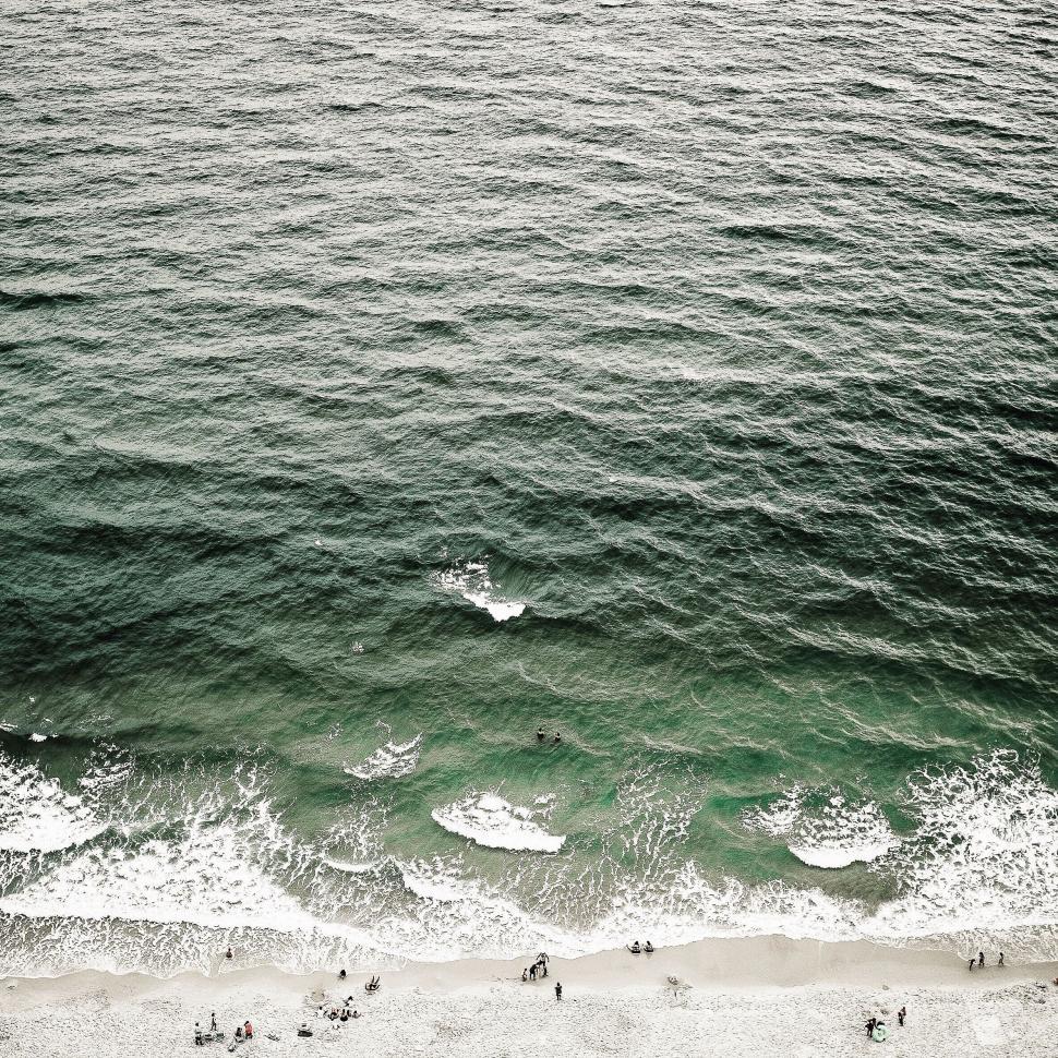 Free Image of Arial beach view with people and waves 