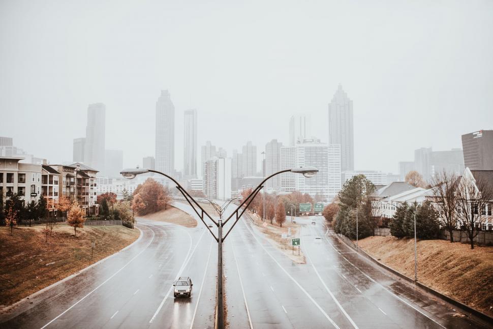Free Image of Cityscape with skyscrapers and a highway on foggy day 