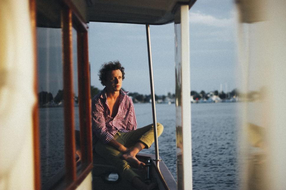 Free Image of Man sitting on boat during golden hour 