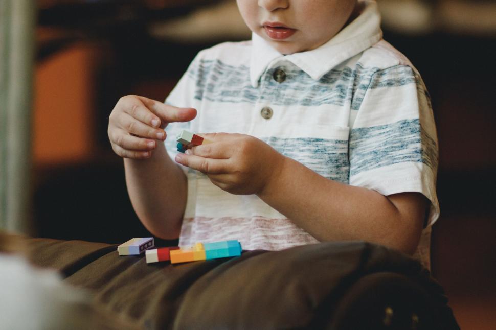 Free Image of Child focused on assembling colorful blocks 