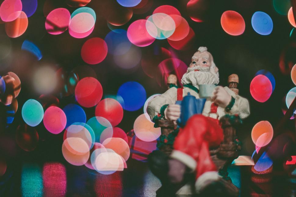 Free Image of Bokeh lights framing a Santa figurine 