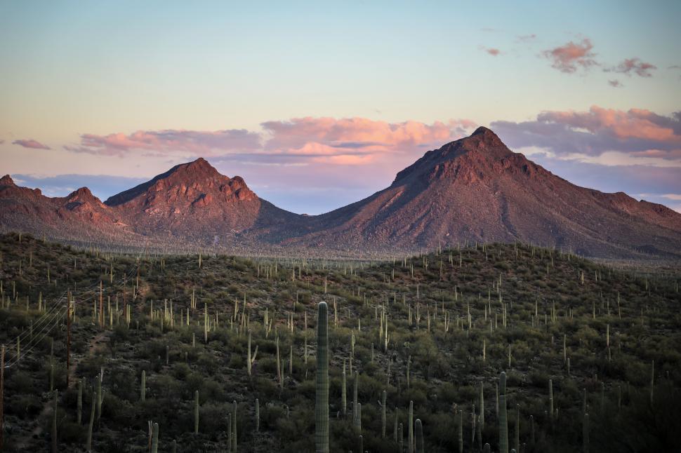 Free Image of Soft setting sunlight over peaceful desert mountains 