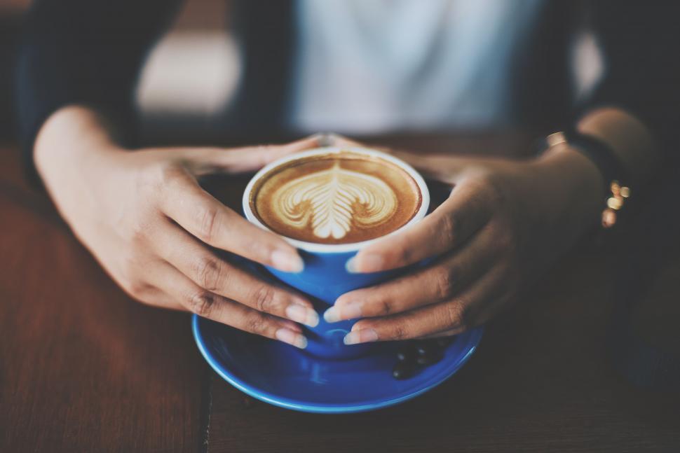 Free Image of Hands holding a cup of coffee 