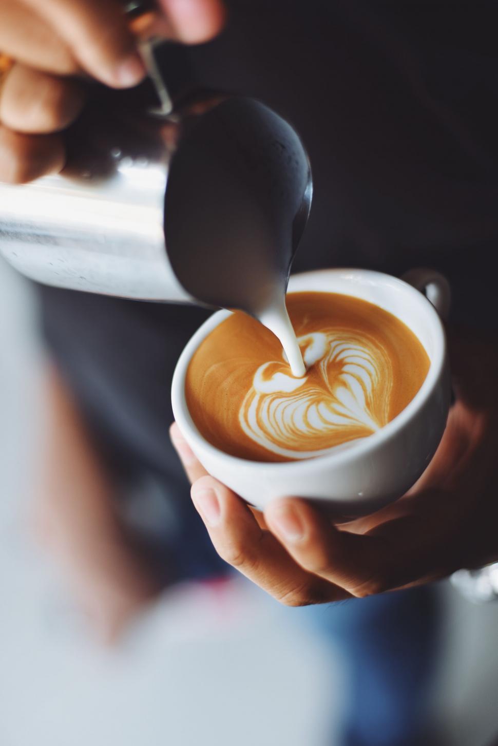 Free Image of Barista pouring milk into a coffee 