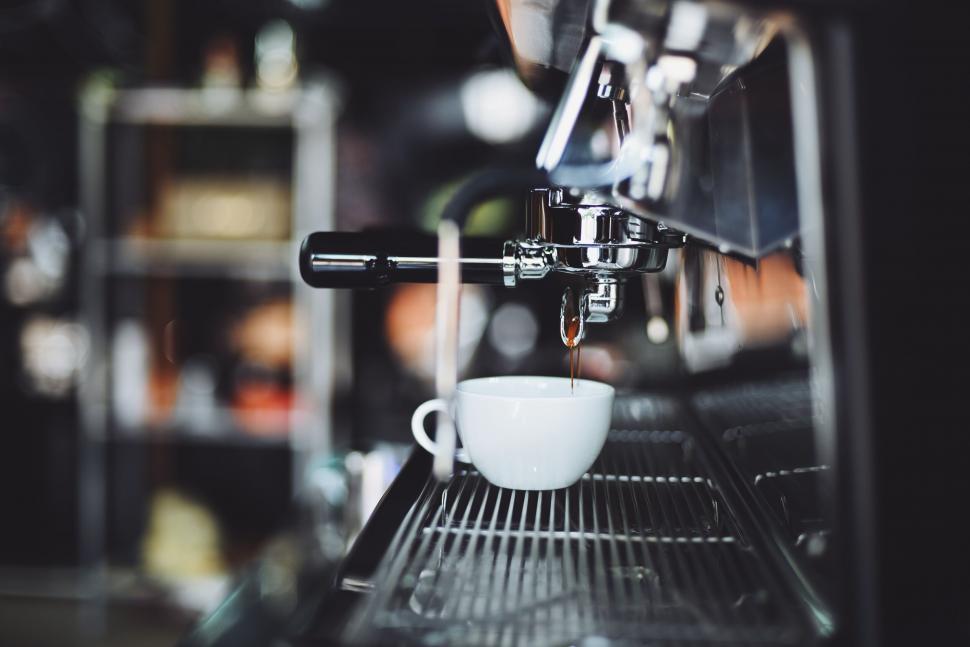 Free Image of Espresso machine brewing into white cup 